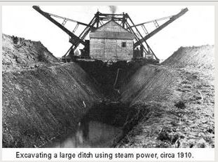 steam shovel creating drainage ditch